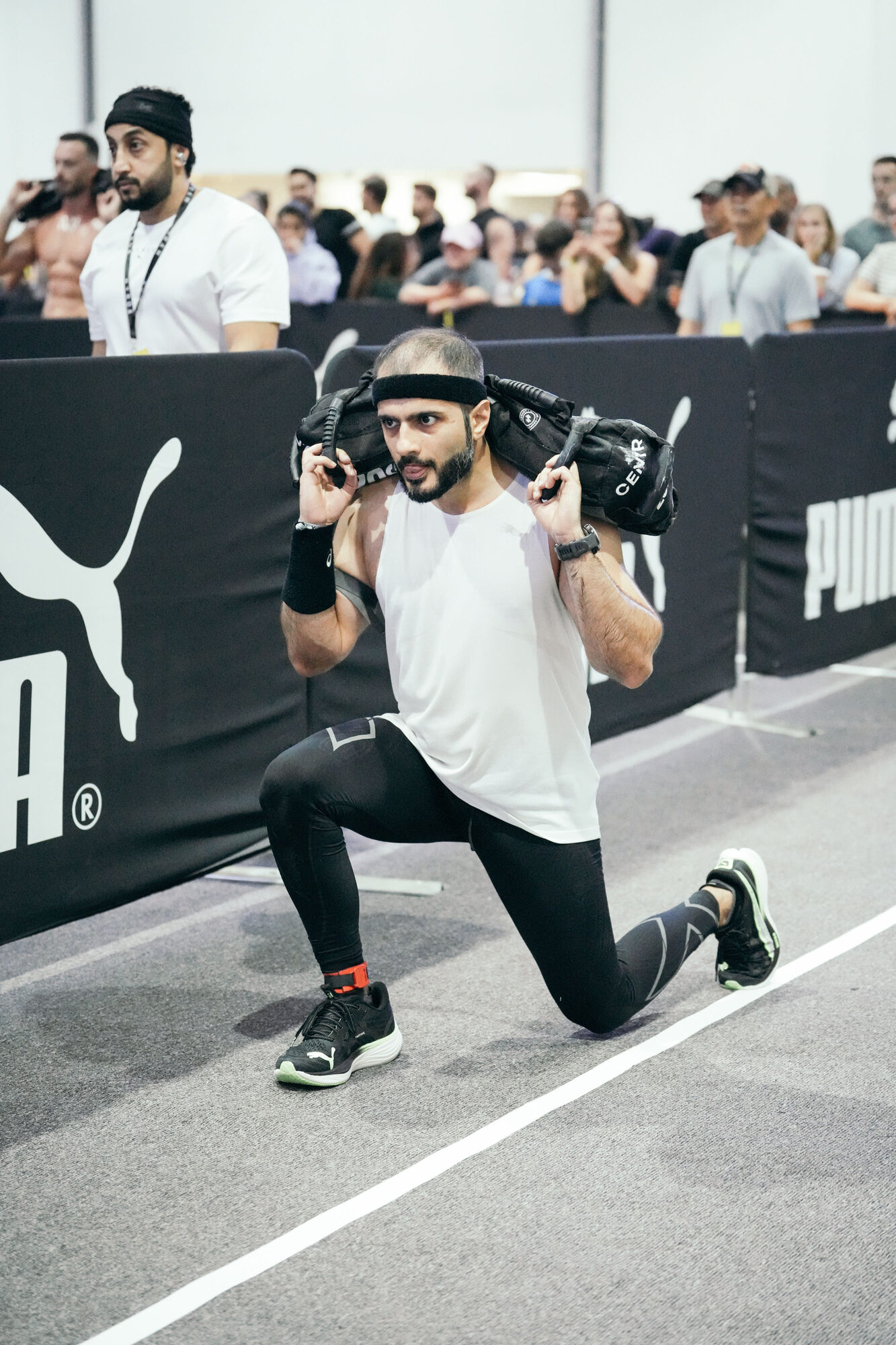 Athlete performing HYROX sandbag lunges
